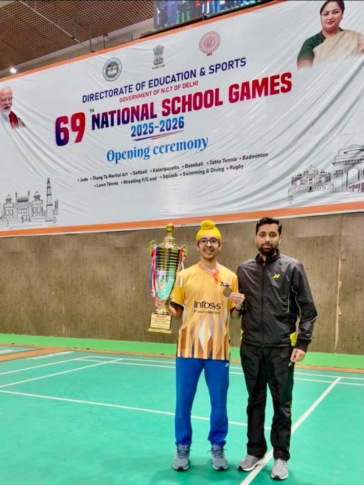 Coach Suresh Kumar with his student, a medallist at the 69th National School Games, on the badminton court