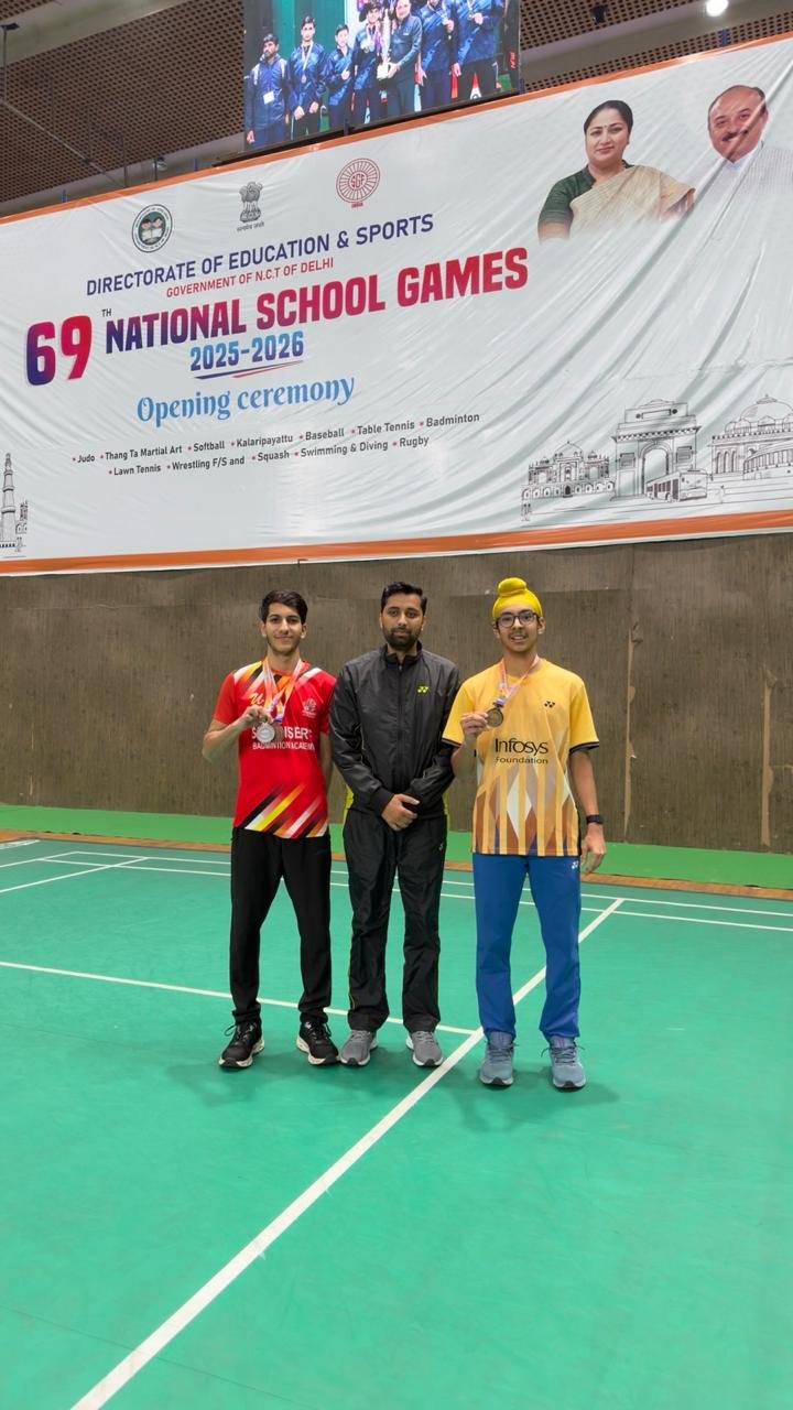 Jagsher Singh and a fellow Punjab player standing under the 69th National School Games banner