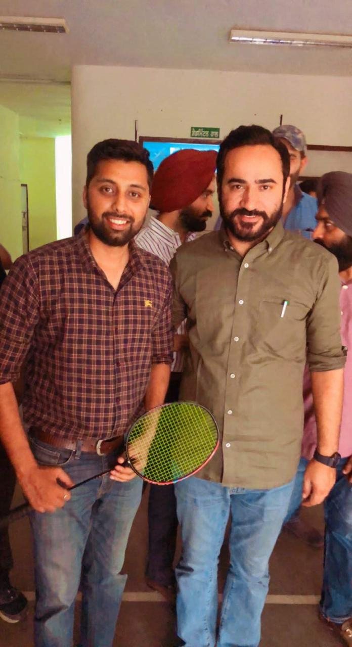 Suresh Kumar and Gurmeet Singh Meet Hayer holding a racket together indoors